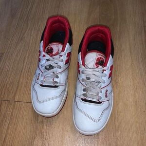 Red, black, and white New Balance 550s